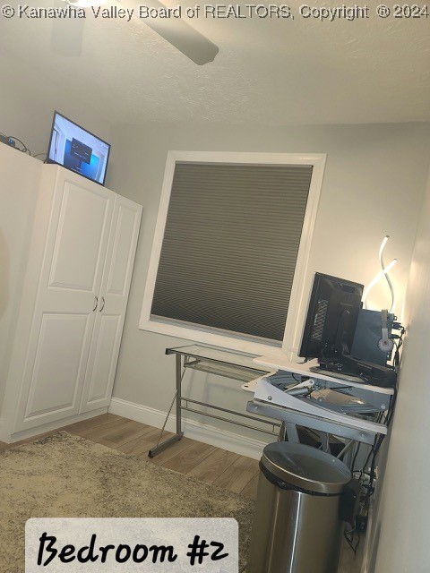 home office featuring ceiling fan and hardwood / wood-style floors