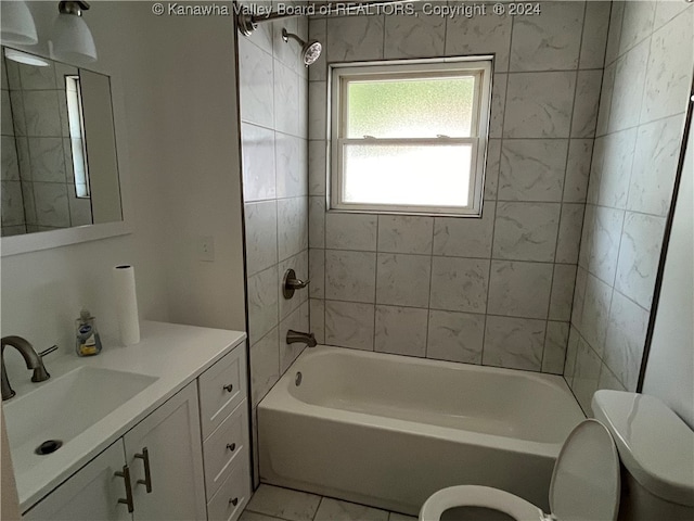 full bathroom featuring tiled shower / bath combo, toilet, tile patterned flooring, and vanity