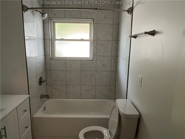 full bathroom with tiled shower / bath, toilet, and vanity