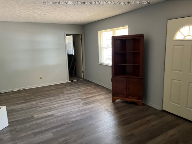 interior space with hardwood / wood-style flooring and a textured ceiling