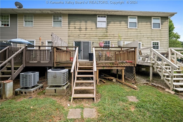 rear view of house featuring a wooden deck and central air condition unit