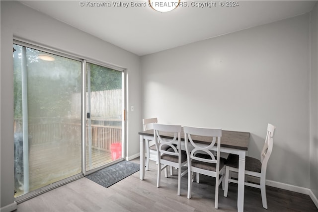 dining area with plenty of natural light and hardwood / wood-style floors