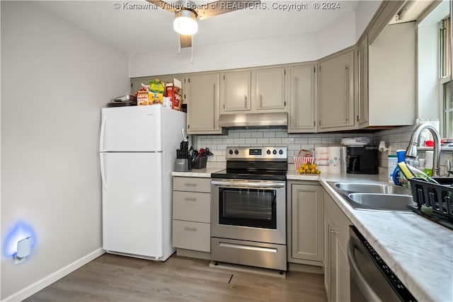 kitchen with ceiling fan, wood-type flooring, tasteful backsplash, and stainless steel appliances