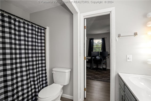 bathroom with wood-type flooring, toilet, and vanity