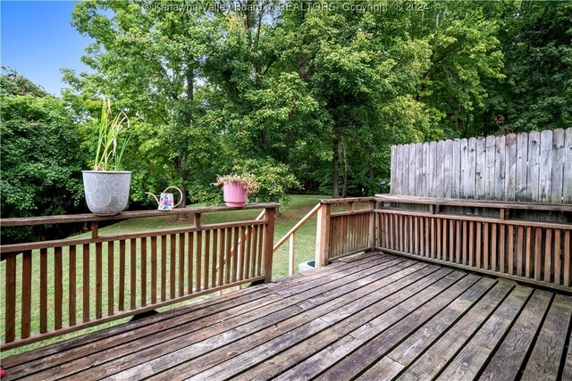 wooden deck featuring a yard