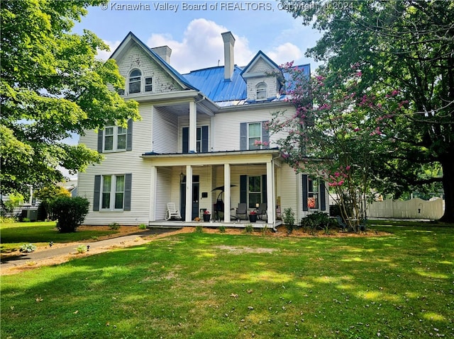 victorian-style house with a front yard