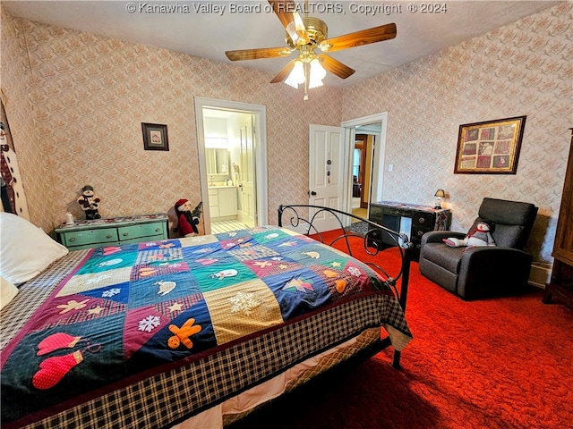 bedroom with ceiling fan, carpet floors, and ensuite bathroom