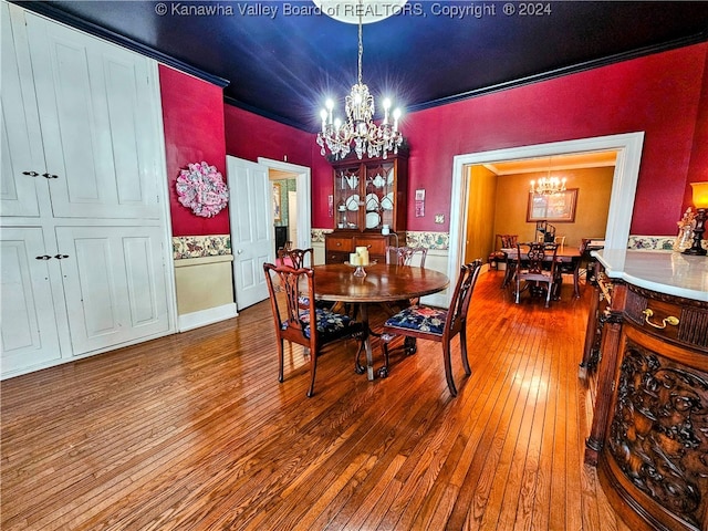 dining room with an inviting chandelier and wood-type flooring