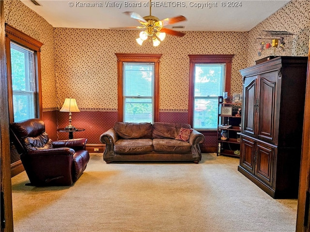 living room with light colored carpet and ceiling fan