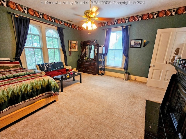 bedroom featuring carpet floors, ceiling fan, and multiple windows