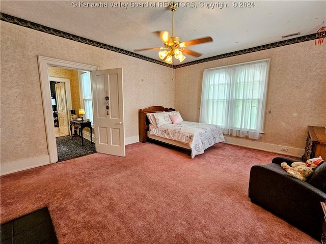 bedroom with ceiling fan and carpet