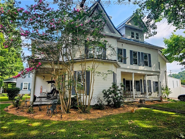 back of property featuring a yard