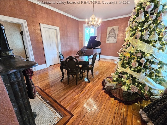 dining room with ornamental molding, an inviting chandelier, and light wood-type flooring