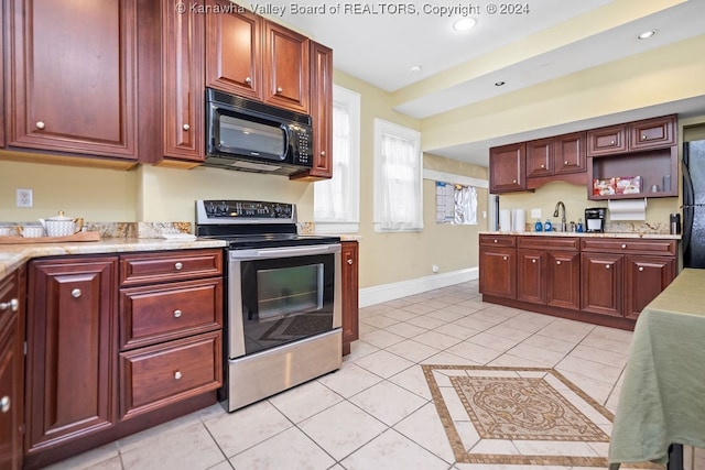 kitchen featuring sink, black appliances, and light tile patterned floors