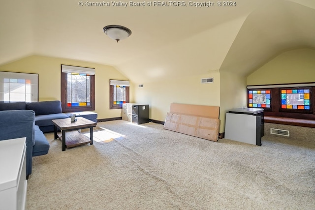 living room with light carpet and vaulted ceiling