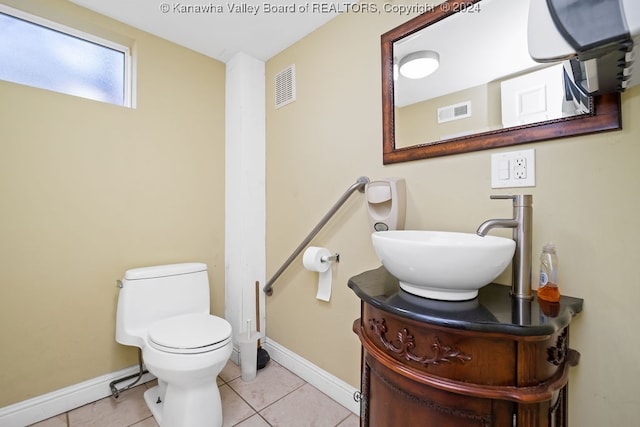 bathroom featuring tile patterned floors, toilet, and vanity