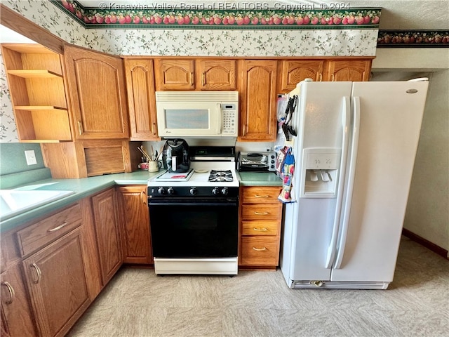 kitchen featuring sink and white appliances