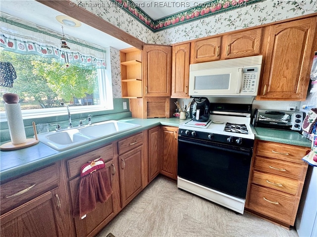 kitchen with light tile patterned floors, sink, and white appliances