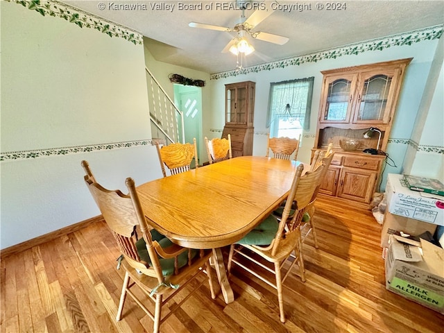 dining area featuring ceiling fan, a textured ceiling, and light hardwood / wood-style floors