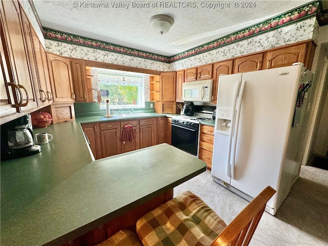 kitchen with sink, a textured ceiling, kitchen peninsula, white appliances, and light carpet