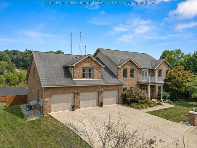 view of front of home with a front lawn and a balcony