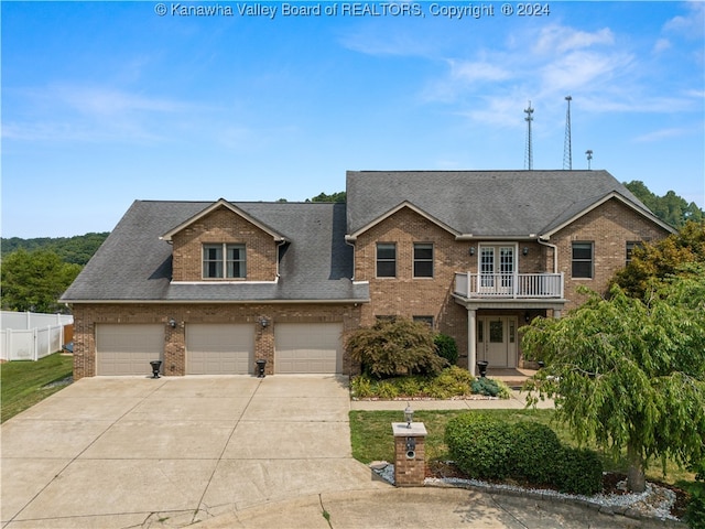 view of front of house featuring a balcony and a garage