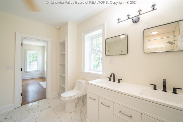 bathroom featuring tile patterned floors, vanity, and toilet