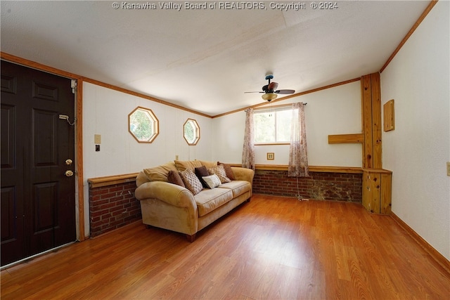 living room featuring hardwood / wood-style flooring, crown molding, and ceiling fan