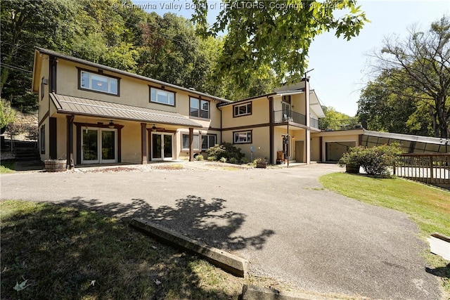 rear view of house with a garage and a lawn