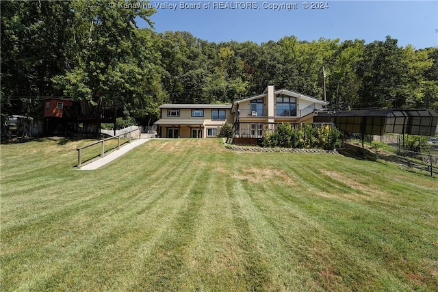 rear view of property featuring an outdoor structure and a lawn