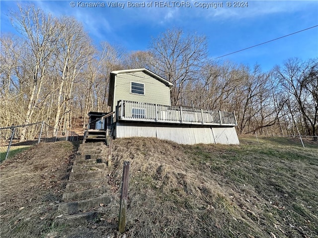 view of side of home with a wooden deck