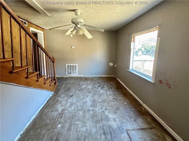 interior space with ceiling fan and a textured ceiling