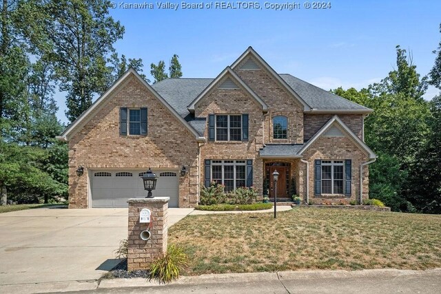 craftsman-style house featuring a front yard and a garage