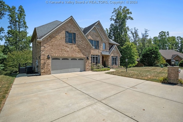 view of front of property with central AC unit and a garage