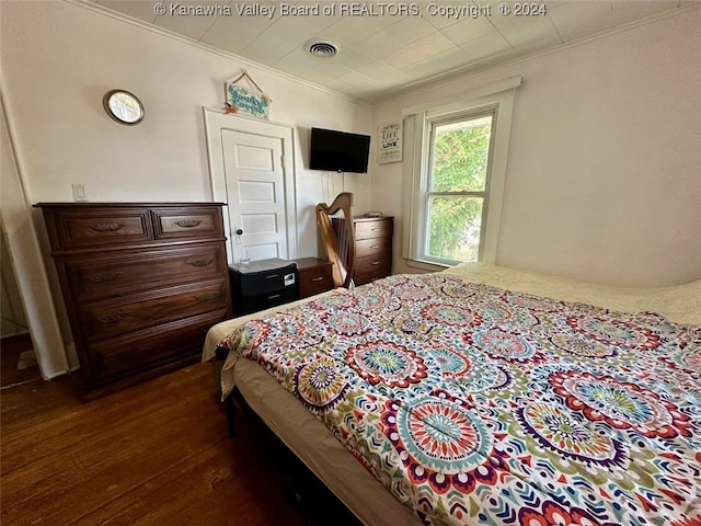 bedroom featuring dark wood-type flooring and ornamental molding