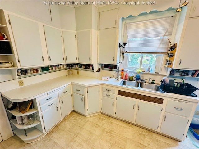 kitchen with white cabinetry and sink