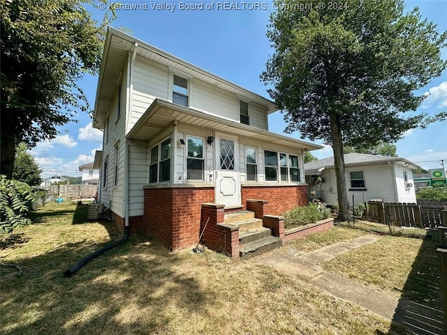 rear view of property with a yard