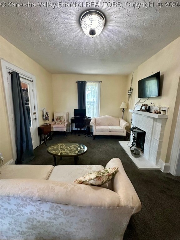 living room with a textured ceiling, carpet floors, and a fireplace