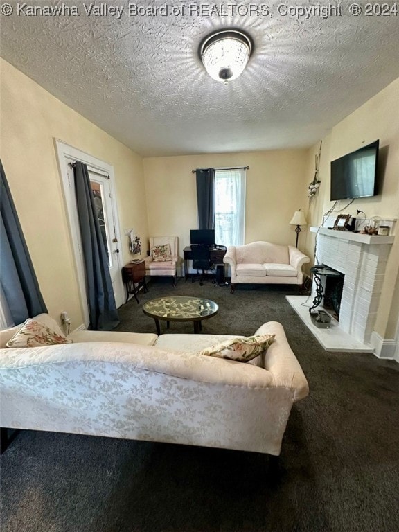 living room with a textured ceiling, carpet floors, and a fireplace