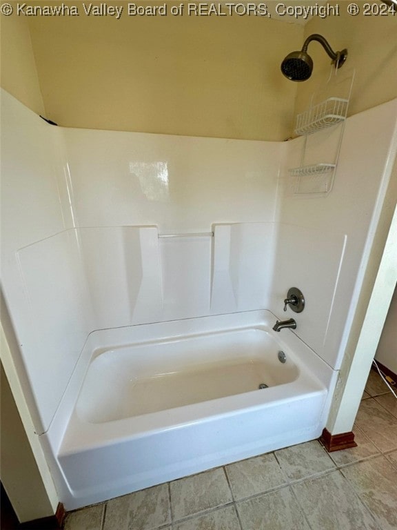 bathroom featuring tile patterned flooring and shower / washtub combination