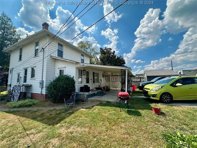 exterior space with a front lawn and a carport