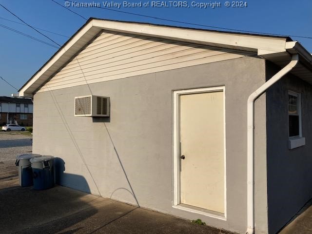 view of property exterior featuring a wall mounted air conditioner