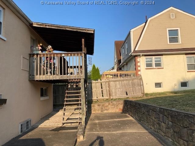 view of side of property with a wooden deck