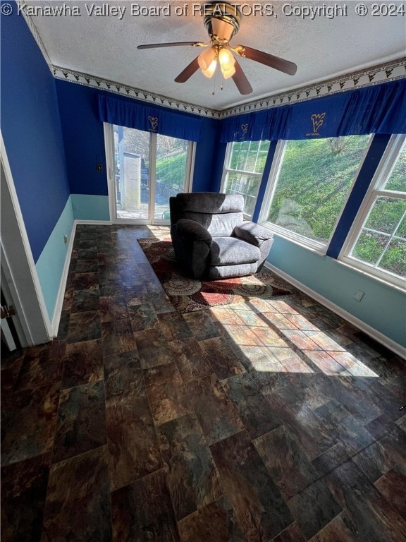 sitting room featuring a textured ceiling and ceiling fan