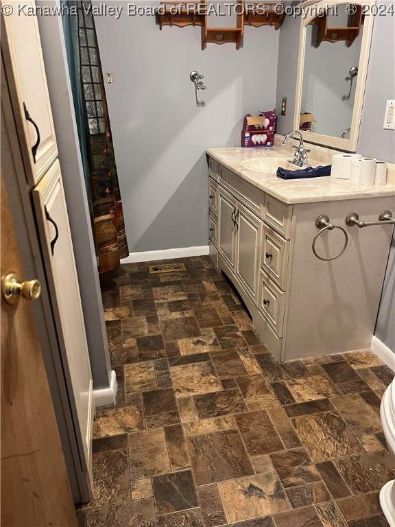 bathroom featuring toilet and vanity