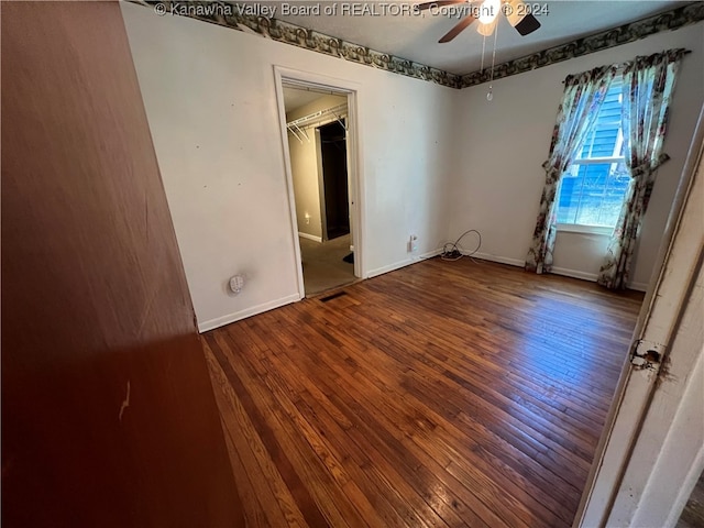 spare room with ceiling fan and wood-type flooring