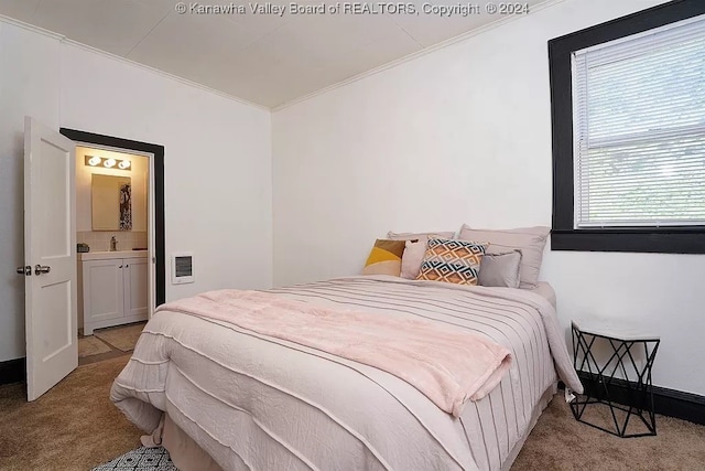 carpeted bedroom featuring crown molding and sink