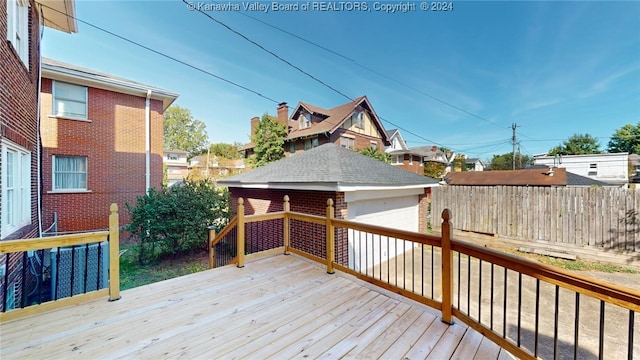 wooden deck featuring an outdoor structure and a garage