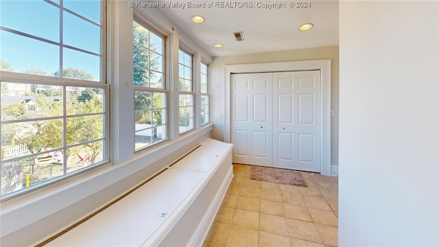 doorway with plenty of natural light and light tile patterned floors