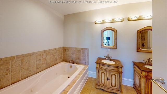 bathroom with tile patterned flooring, vanity, and a relaxing tiled tub